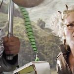Still from Harry Potter ad the Goblet of Fire: Middle-aged blond woman with cat-eye glasses (Rita Skeeter) with quill and pad of paper.
