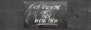 Chalkboard with white words: First learn the rules then break them.