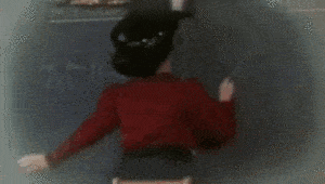 Gif of a woman in early 20th-century dress writing 