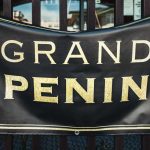 Black banner with yellow lettering: Grand Reopening, in front of store.