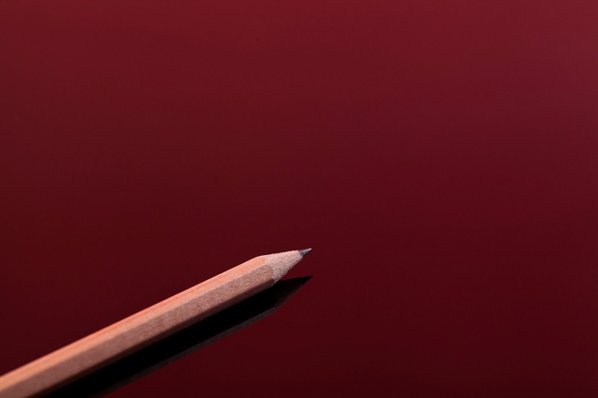 Pencil against a red background
