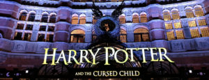 Exterior of theater at night with design of child curled up in a nest and the title: Harry Potter and the Cursed Child